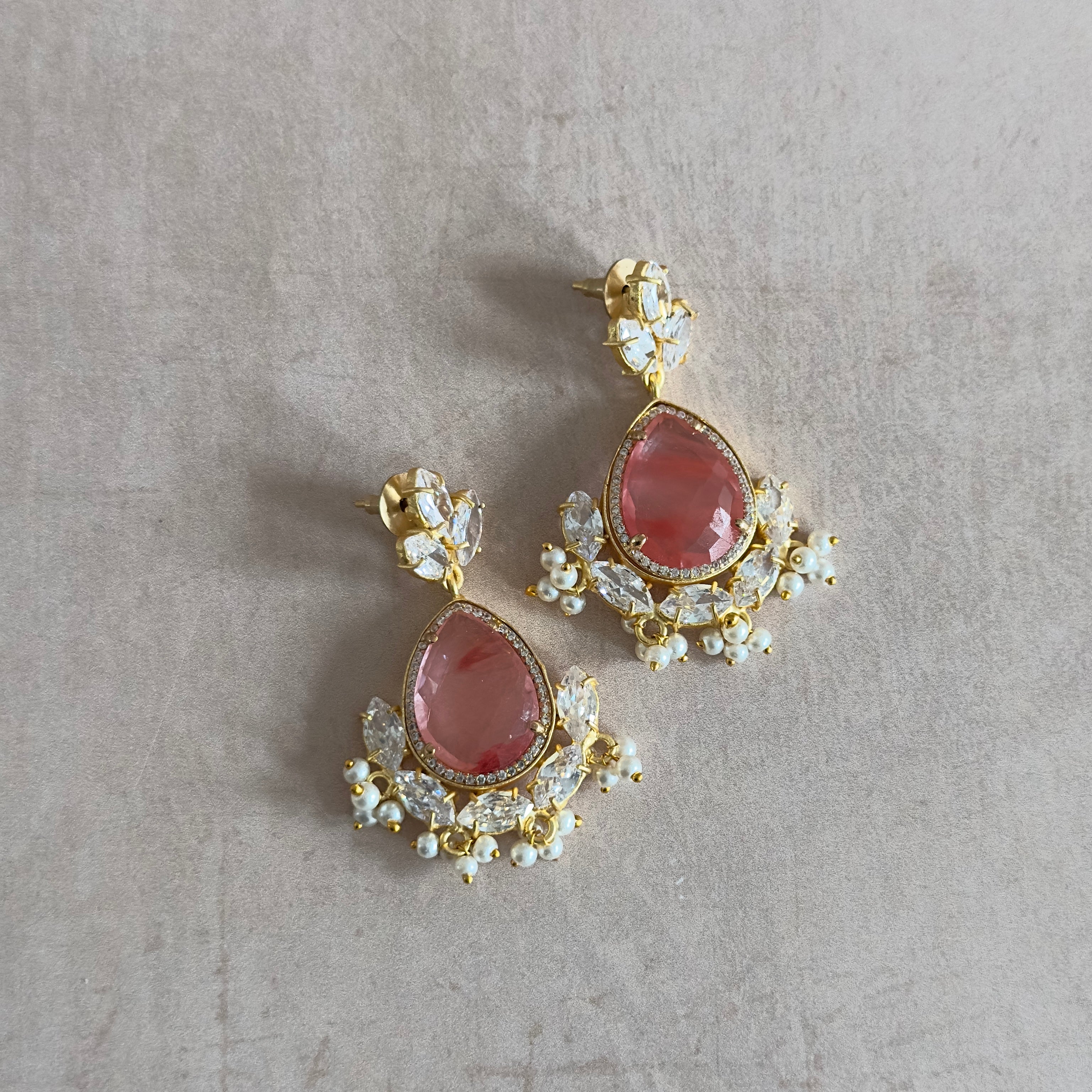 Add a pop of color to your summer outfits with Felice Crystal Drop Earrings! The crimson crystal and cubic zirconia stones add a touch of sophistication to any look, while the statement design exudes summer vibes. Elevate your style and turn heads with these must-have earrings!