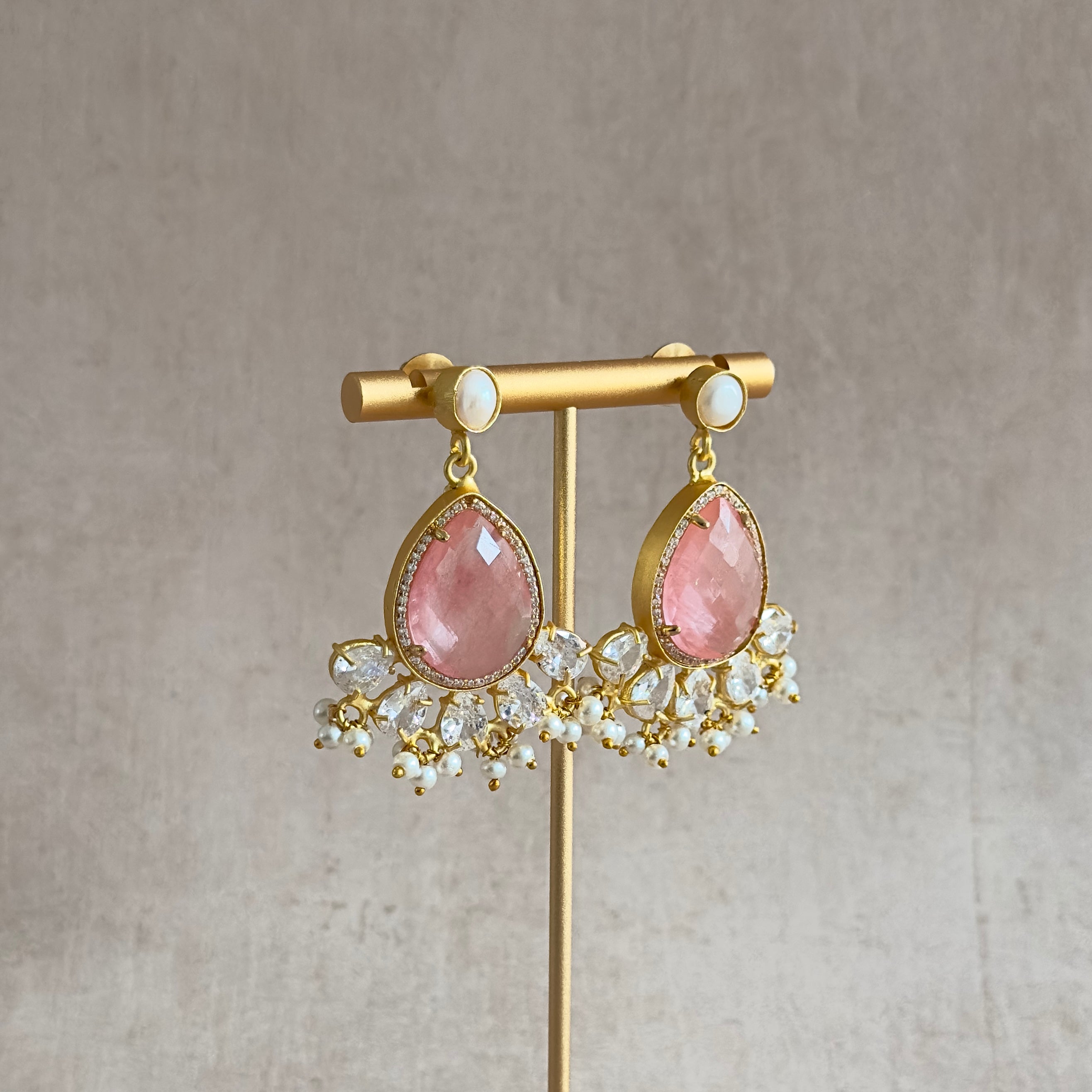 Enhance your style with our Molly Crystal Drop Earrings! Featuring a stunning crimson crystal with delicate pearl accents and sparkling cubic zirconia, these earrings will add a touch of elegance and glamour to any outfit. Elevate your look and shine bright with these eye-catching earrings.