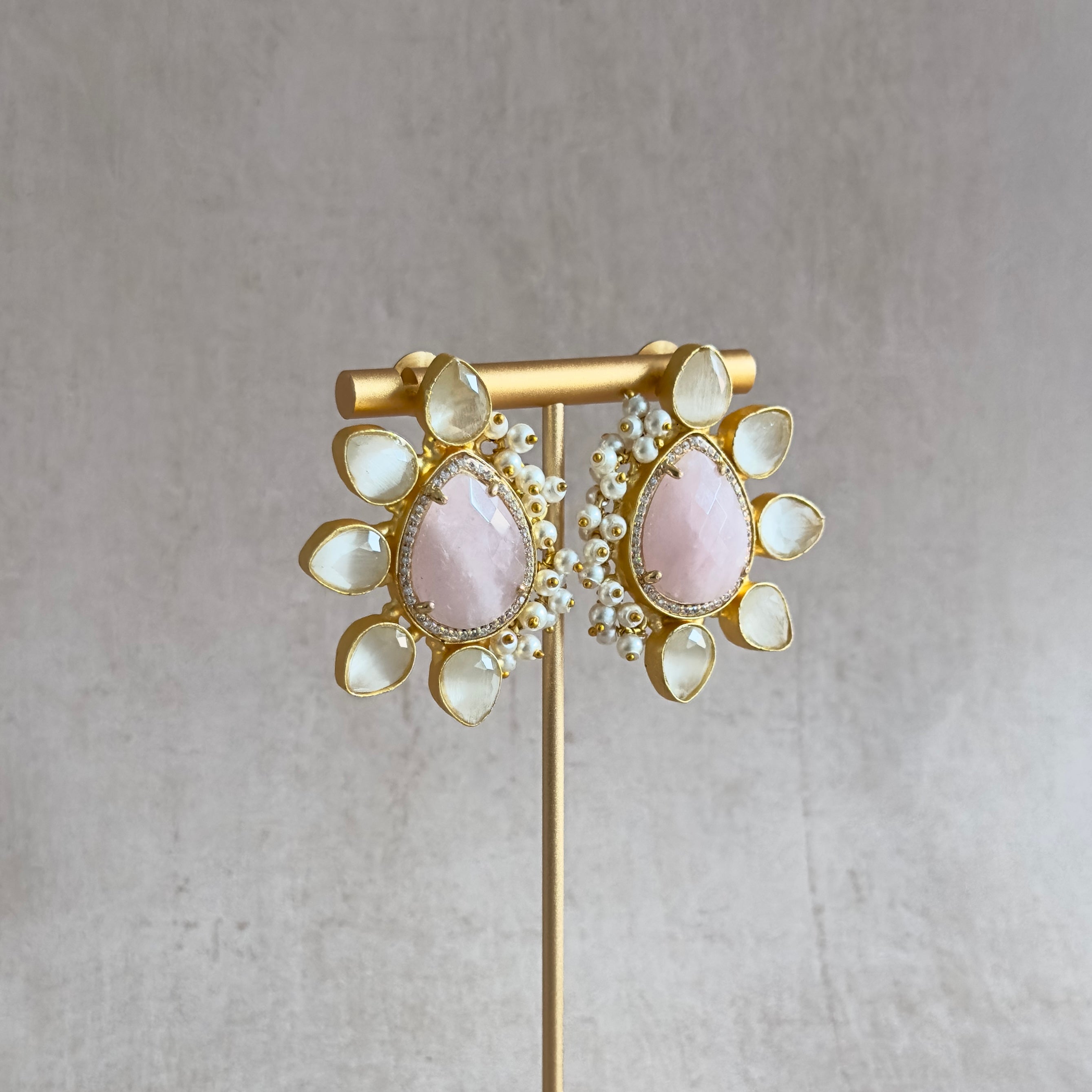 Add a pop of color to your outfit with our Amara Pink Stud Earrings! These statement studs feature stunning hues of pink and grey, sure to make a bold statement. Elevate your accessory game and stand out from the crowd with these eye-catching earrings.