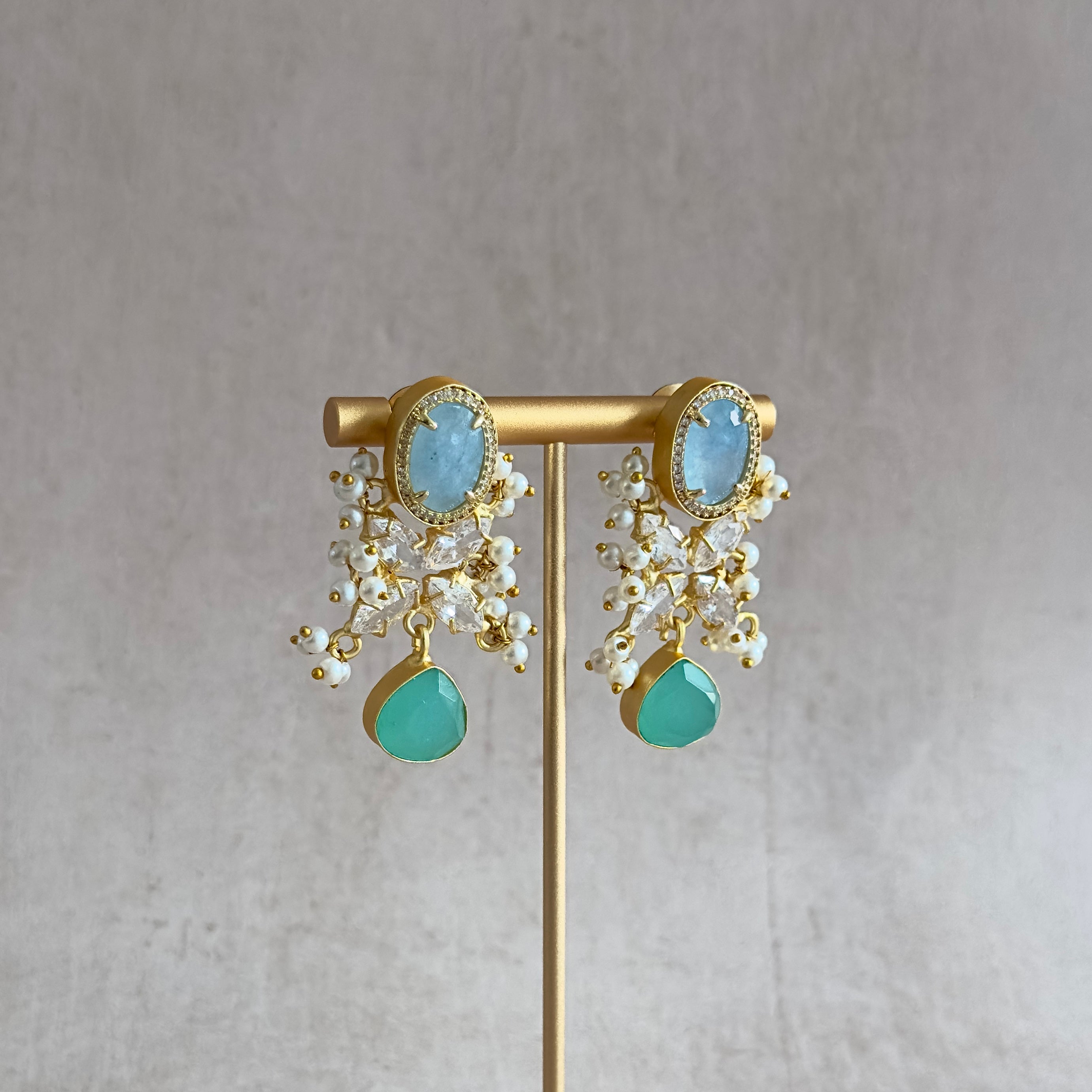 Sparkle and shine with our Madiha Mint Crystal Drop Earrings! Featuring stunning hues of blue and mint, these earrings are sure to catch anyone's eye. The cubic zirconia adds an extra touch of elegance and sparkle. Elevate any outfit with these dazzling earrings!
