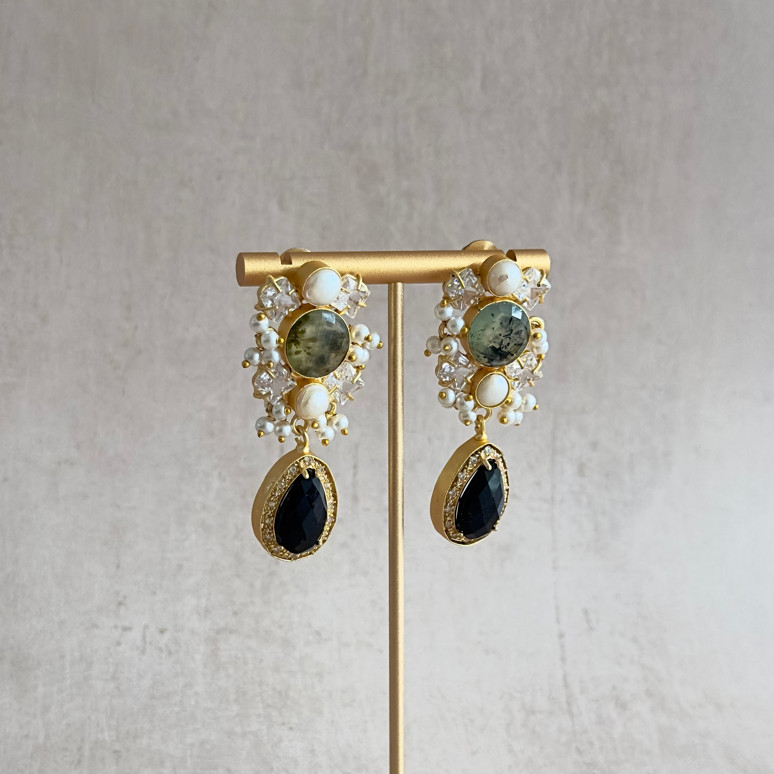 Add a touch of elegance to any outfit with our Lela Black Pearl Earrings! These stunning multi gemstone earrings feature sparkling CZ crystals, bringing a touch of glamour and sophistication to your look. Perfect for any occasion, these earrings are sure to make a statement and elevate your style.