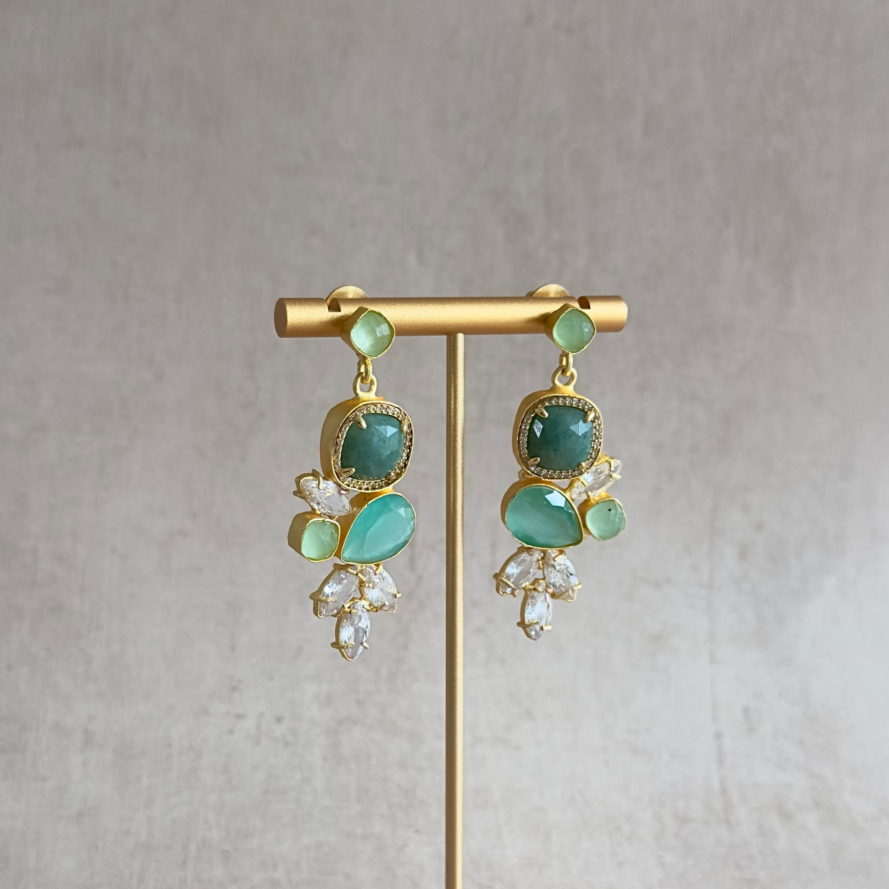 Indulge in the captivating tones of the Malika Mint Drop Earrings. The stunning hues of green, accented with sparkling CZ crystals, will add a touch of elegance to any outfit. Elevate your style and feel radiant with these gorgeous earrings.