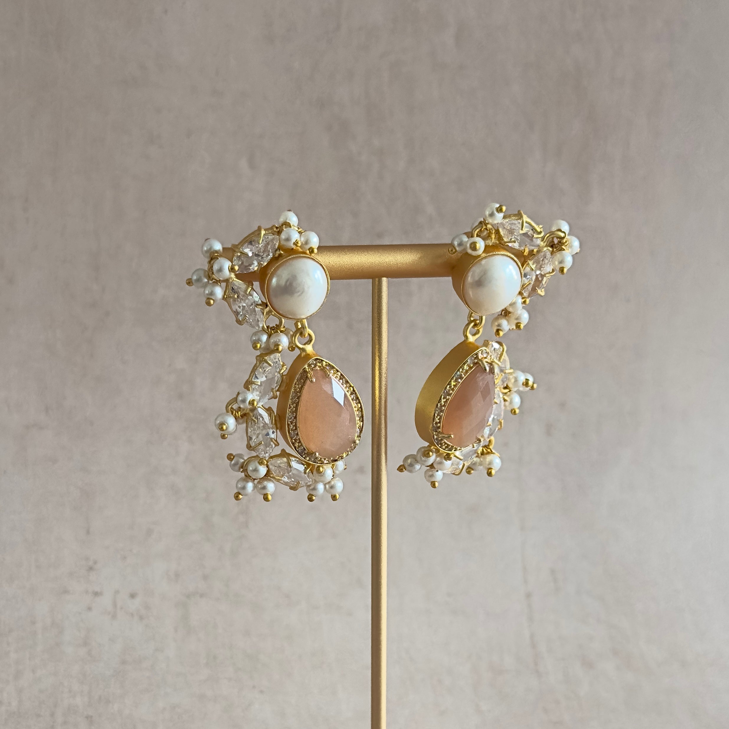 Transform your look with our Peachy Pearl Drop Earrings! Each piece is delicately crafted with peach moonstone and freshwater pearls to add a touch of elegance and natural beauty to any outfit. Elevate your style and embrace the benefits of these stunning earrings.