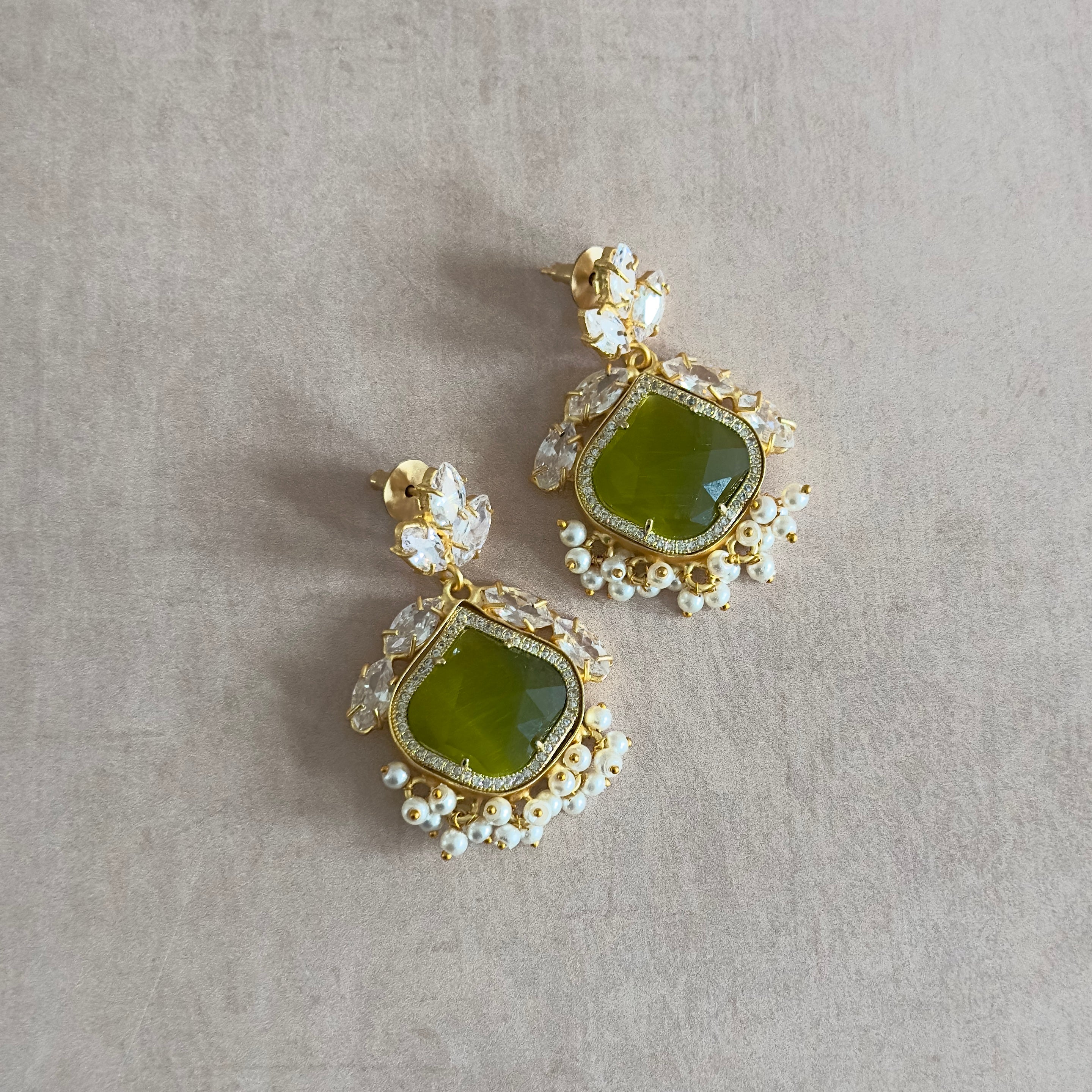 Elevate your look with our Olive Crystal Drop Earrings! The vibrant olive stone and sparkling CZ crystals make a stunning statement, adding a touch of glam to any outfit. Feel confident and effortlessly stylish with these stunning earrings. Perfect for any occasion!