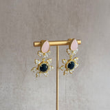 These Nelly Pink Drop Crystal Earrings are the perfect blend of sophistication and eye-catching style. The black onyx, pink stones, and CZ crystals come together to create a stunning combination that will elevate any outfit. Show off your unique sense of fashion with these must-have earrings.