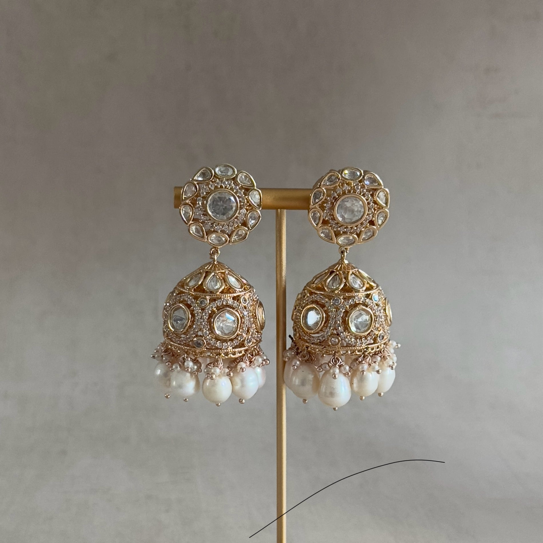 Make a statement in our classic Aaliya Kundan Set. Intricately crafted with a blend of traditional and modern design, the Alia Pearl Choker Set is a timeless accessory to elevate any ensemble. The kundan - embellished choker features exquisite pearls, accompanied by elegant Jhumka earrings for a lavish look.