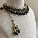 Elevate your outfit with our Keira Black Choker Set! This stunning set features Black Onyx beads in a elegant antique gold finish. The adjustable tie allows for the perfect fit, while the matching earrings and tikka complete the look.&nbsp;