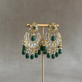 This Rani Green Kundan Choker Set is nothing short of exquisite. Featuring a delicate kundan setting, lush green beads, and captivating chaandbali earrings, this set is a must-have for those who appreciate the splendor of luxurious jewelry. The matching tikka completes the look, elevating it to a higher level of opulence.