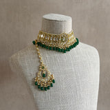 This Rani Green Kundan Choker Set is nothing short of exquisite. Featuring a delicate kundan setting, lush green beads, and captivating chaandbali earrings, this set is a must-have for those who appreciate the splendor of luxurious jewelry. The matching tikka completes the look, elevating it to a higher level of opulence.