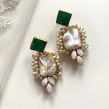 A fashion staple, these Green Baroque Earrings are handcrafted with a baroque pearl and an emerald stone, making them one of our bestsellers. Their polished stone and natural luster are sure to add a touch of elegance to any ensemble.  Details: Earring drop approx 7cm Shape of pearls may vary.