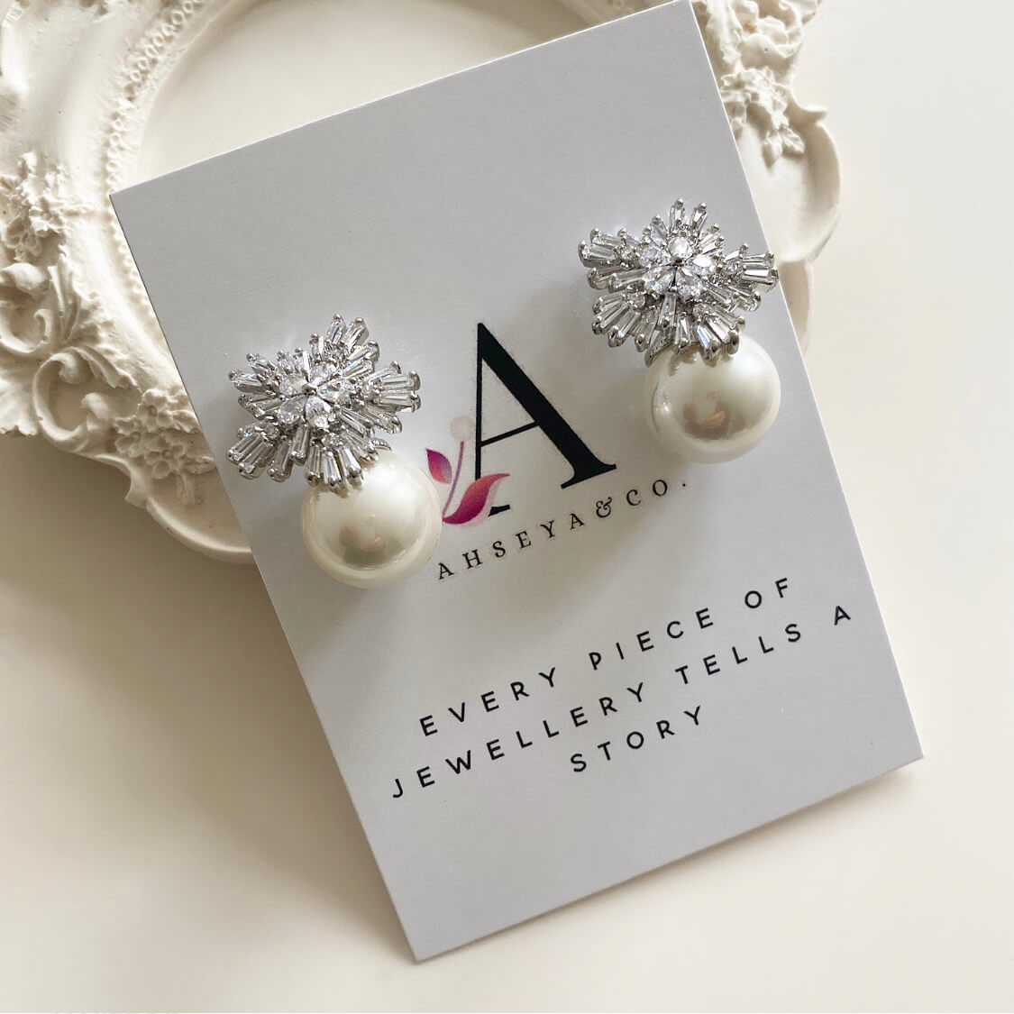These lovely pearl cluster earrings feature a classic pearl, surrounded by a cluster of sparkling cubic zirconia crystals. The combination of luminescent pearl and sparkling crystals make these earrings the perfect choice for any special occasion.