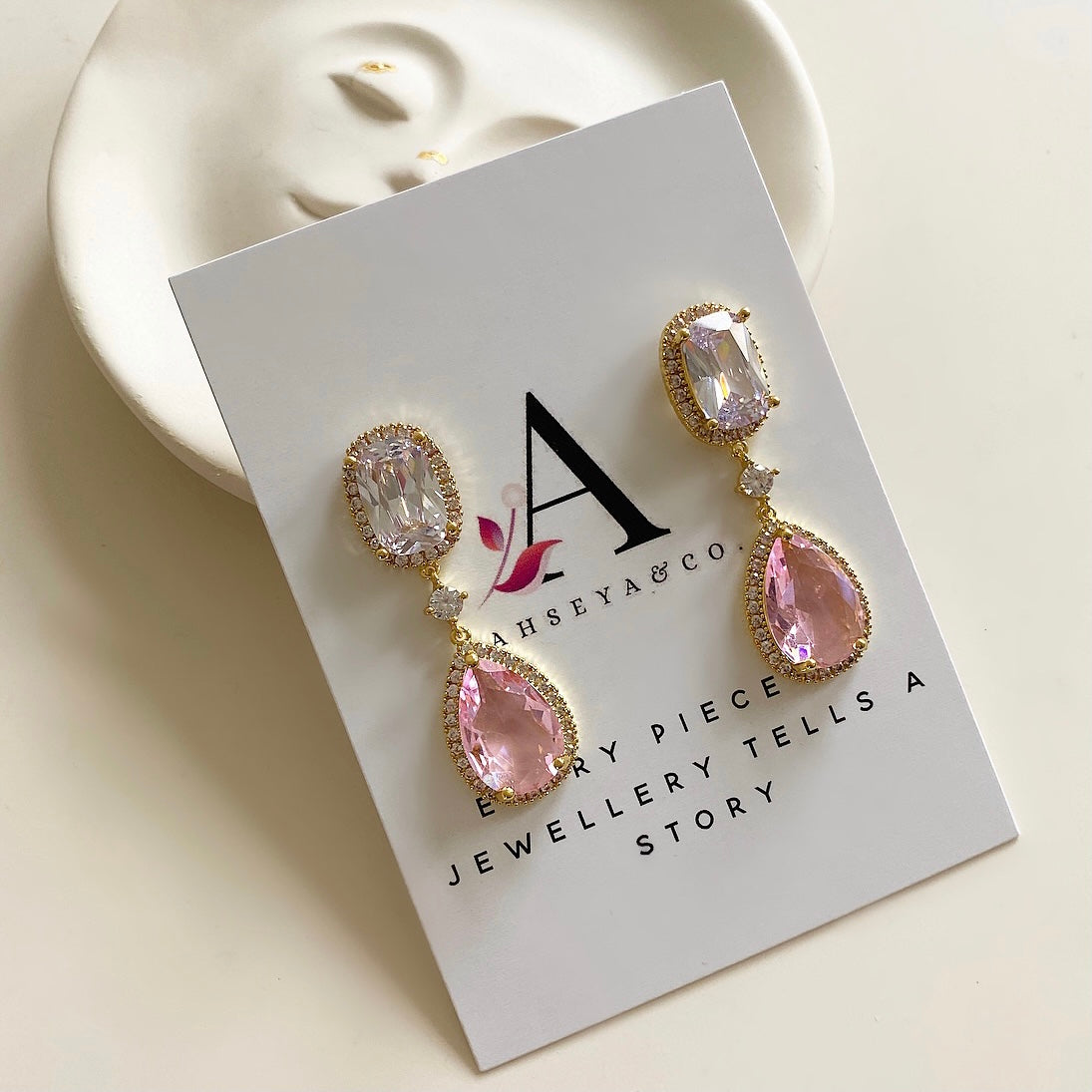 These sparkling Pink Crystal  Earrings, crafted with cz crystals, will add a touch of elegance and sparkle to any ensemble. The exquisite drop earring design and dazzling cubic zirconia crystals will make you shine. Elevate your style and make a stunning statement with these beautiful earrings. Available in a silver & gold finish. Earring drop 4.2cm