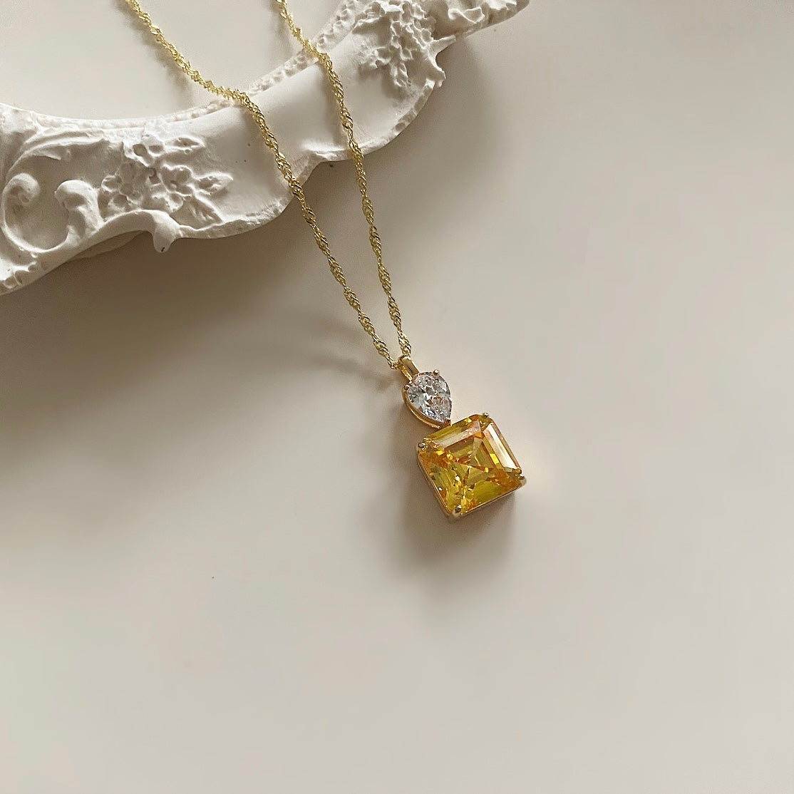 Indulge in luxury with the Saali Crystal Necklace. Made of gold plated sterling silver, this elegant necklace is embellished with shimmering cubic zirconia stones. Elevate any outfit with this stunning accessory and dazzle with every step.