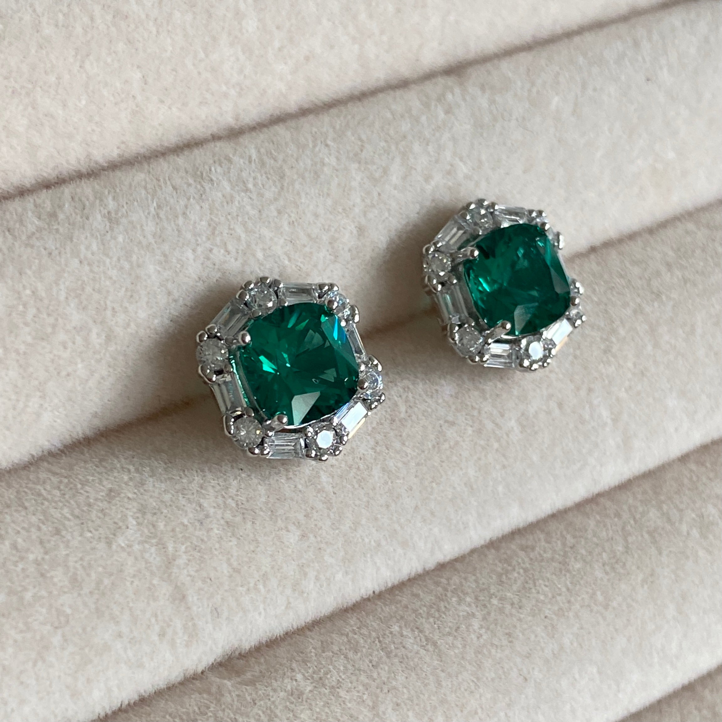 These classic Emerald Studs feature emerald-cut, CZ crystals set in a stunning 925 sterling silver frame. Delicate and timeless in design, these earrings will add the perfect touch of sophistication to any ensemble.  Earring Drop 1x1cm 
