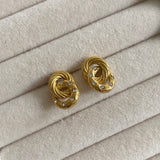 Twist Crystal Studs are the perfect way to add subtle sophistication to any look. Crafted from faceted crystals, these studs shimmer and sparkle in the light, catching eyes with their subtle yet striking style. The classic, minimalist design is perfect for any wardrobe.  18k gold plated  Earring drop 3.5cm