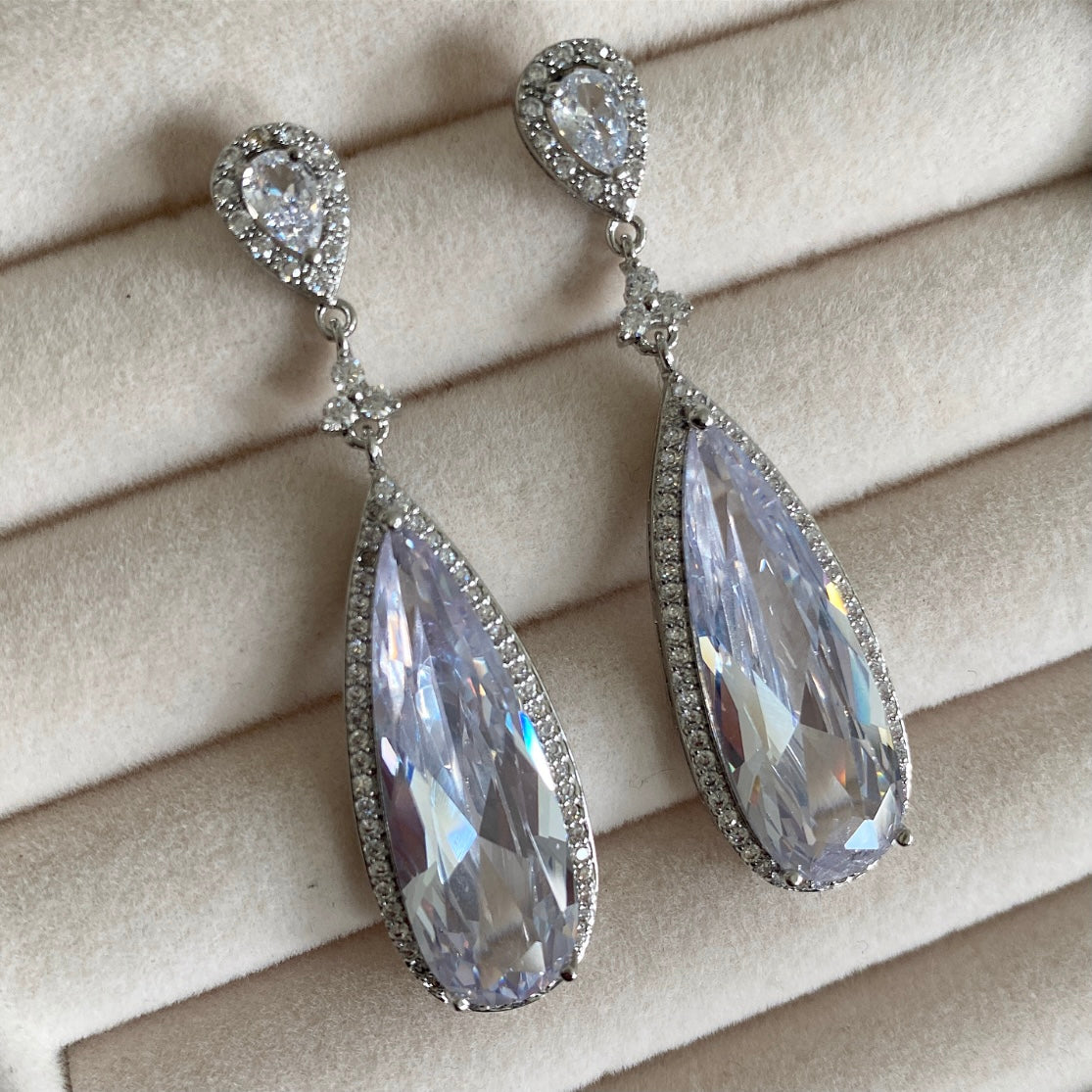 These Reva Crystal Drop Earrings feature a sleek and sophisticated design with a dazzling crystal drop. Crafted with premium quality cz crystals, these earrings sparkle and glimmer in any light, making them the perfect accessory for any occasion. Long-lasting and resistant, these earrings are sure to be an eye-catching addition to your look. Earring drop 5.5cm