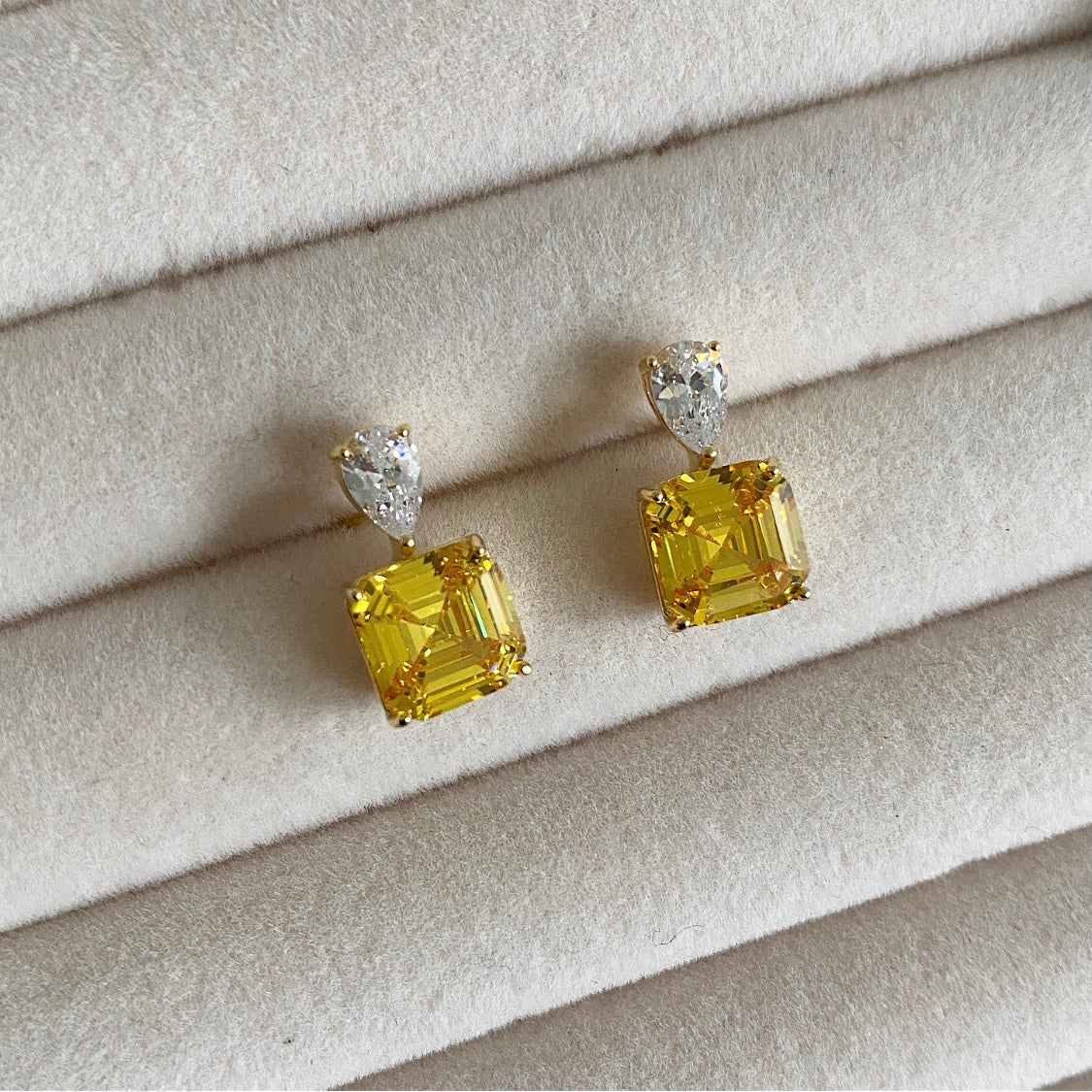 Experience the luxurious beauty of our Saali Crystal Earrings. Adorned with sparkling yellow cubic zirconia, these gold plated sterling silver earrings will elevate any outfit. Treat yourself or your loved ones to our exquisite and timeless pieces. Pair with Salli crystal necklace for a complete look.