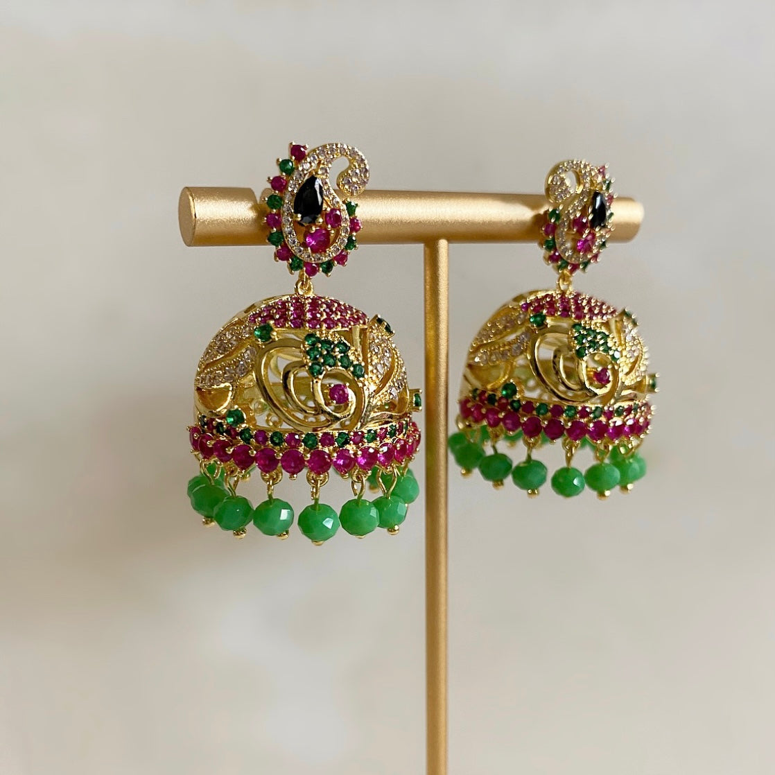 Our Mini Paisley Jhumki Earrings boast a beautiful paisley design with shimmering crystal zirconia and rich, vivid colours to add a touch of style and sparkle to any outfit. Perfect for any occasion, they will bring out the best in any outfit.  Earring drop 4cm 